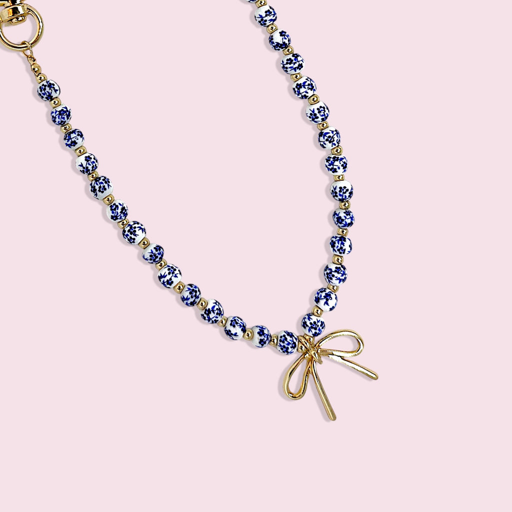 Blue & White Porcelain Bead Bag Charm – Gold Bow Accent