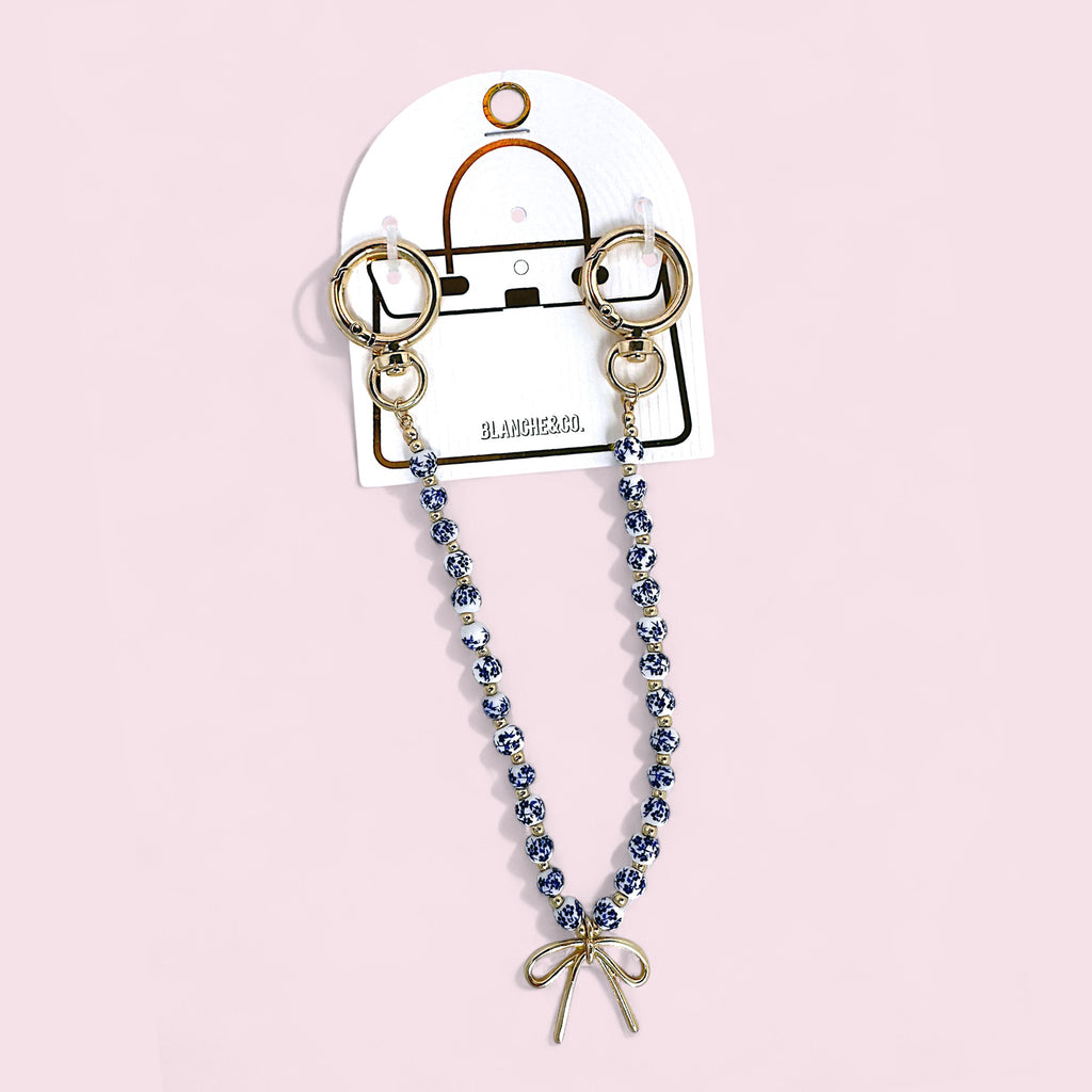 Blue & White Porcelain Bead Bag Charm – Gold Bow Accent