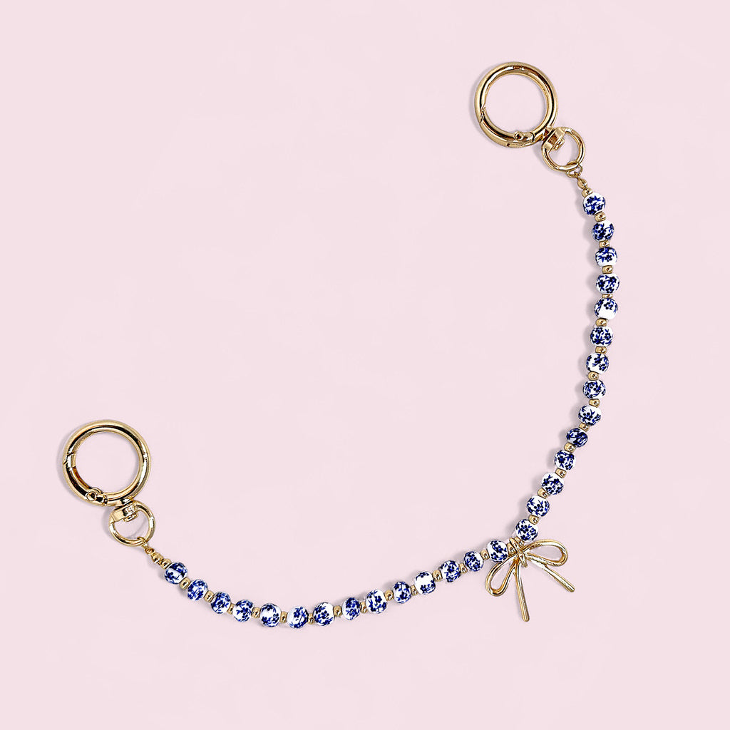 Blue & White Porcelain Bead Bag Charm – Gold Bow Accent